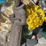 Easter service statue, daffodils, stones