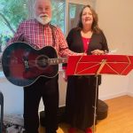 Rob with guitar and Jacqueline