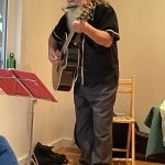 Rob playing guitar and harmonica